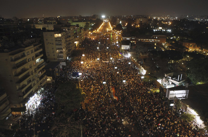 Protesters opposing
Egyptian President Mohamed Morsi wave Egyptian flags and shout
slogans against him and members of the Muslim Brotherhood, during
a protest in front of El-Thadiya presidential palace in Cairo
June 30, 2013. (Reuters)