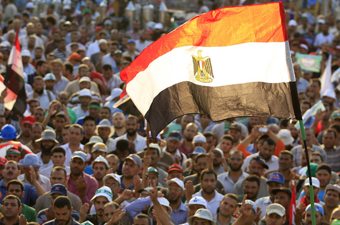 Members of the Muslim Brotherhood and supporters of Egyptian
President Mohamed Morsi shout slogans and waves an Egyptian flag
during a protest around the Raba El-Adwyia mosque square in Nasr
City, in the suburb of Cairo June 29, 2013. (Reuters)