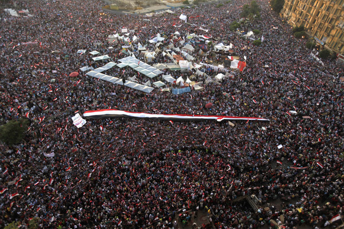 A large Egyptian flag
is seen as protesters opposing Egyptian President Mohamed Morsi
shout slogans against him and Brotherhood members during a
protest at Tahrir Square in Cairo June 30, 2013. (Reuters)
